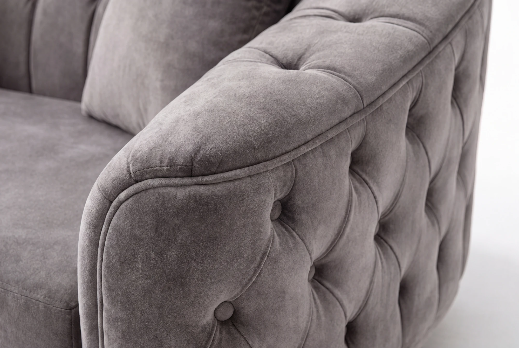 Close-up of the rounded arm with piped edging