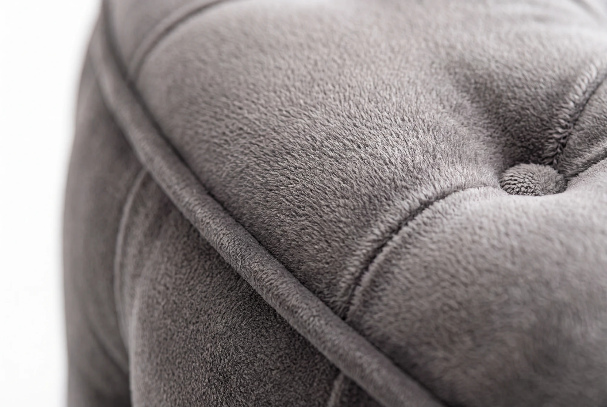 Close-up of a tufted button and the soft pile of the fabric
