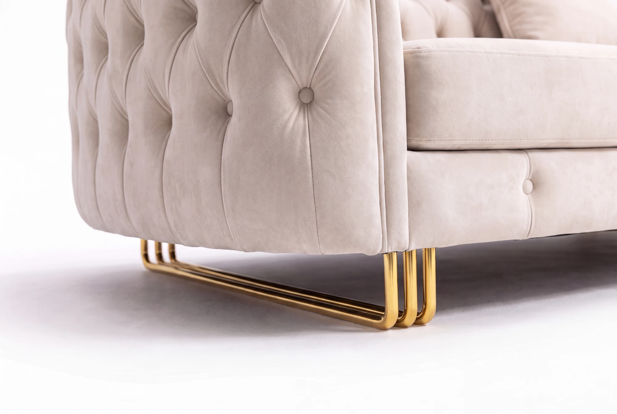 Close-up of the gold-tone leg and tufted side